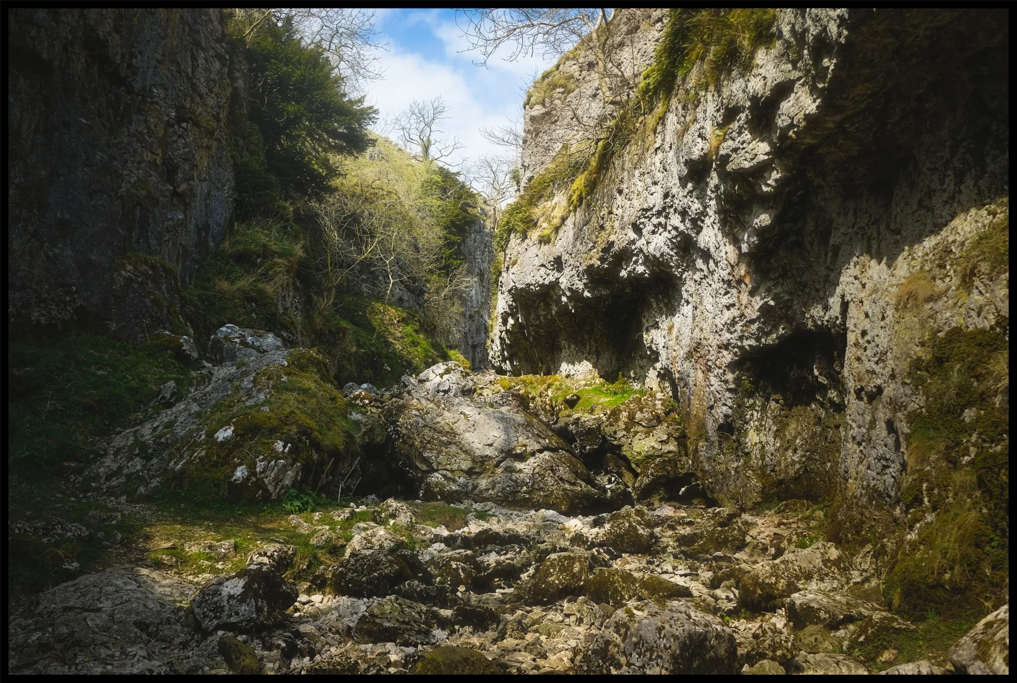  The entrance to Trollers Gill, largely dry for most of the year. Historically this would&rsquo;ve been the site of a thunderous ravine with several waterfalls and cascades crashing down the gill. Thousands of years of erosion in a limestone landscape means the beck at the top of the gill now goes underground before entering the ravine, later reemerging at the bottom of Trollerdale. 