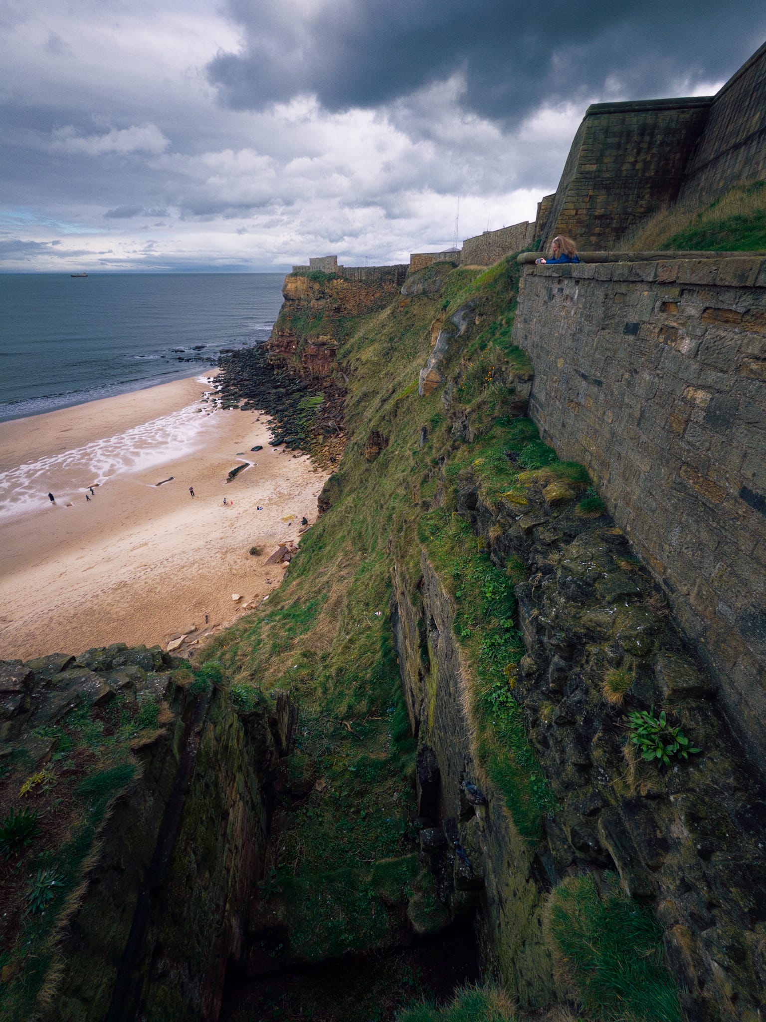 From the walls of the Priory, looking straight down the crag&rsquo;s cliffs to King Edward&rsquo;s Bay.