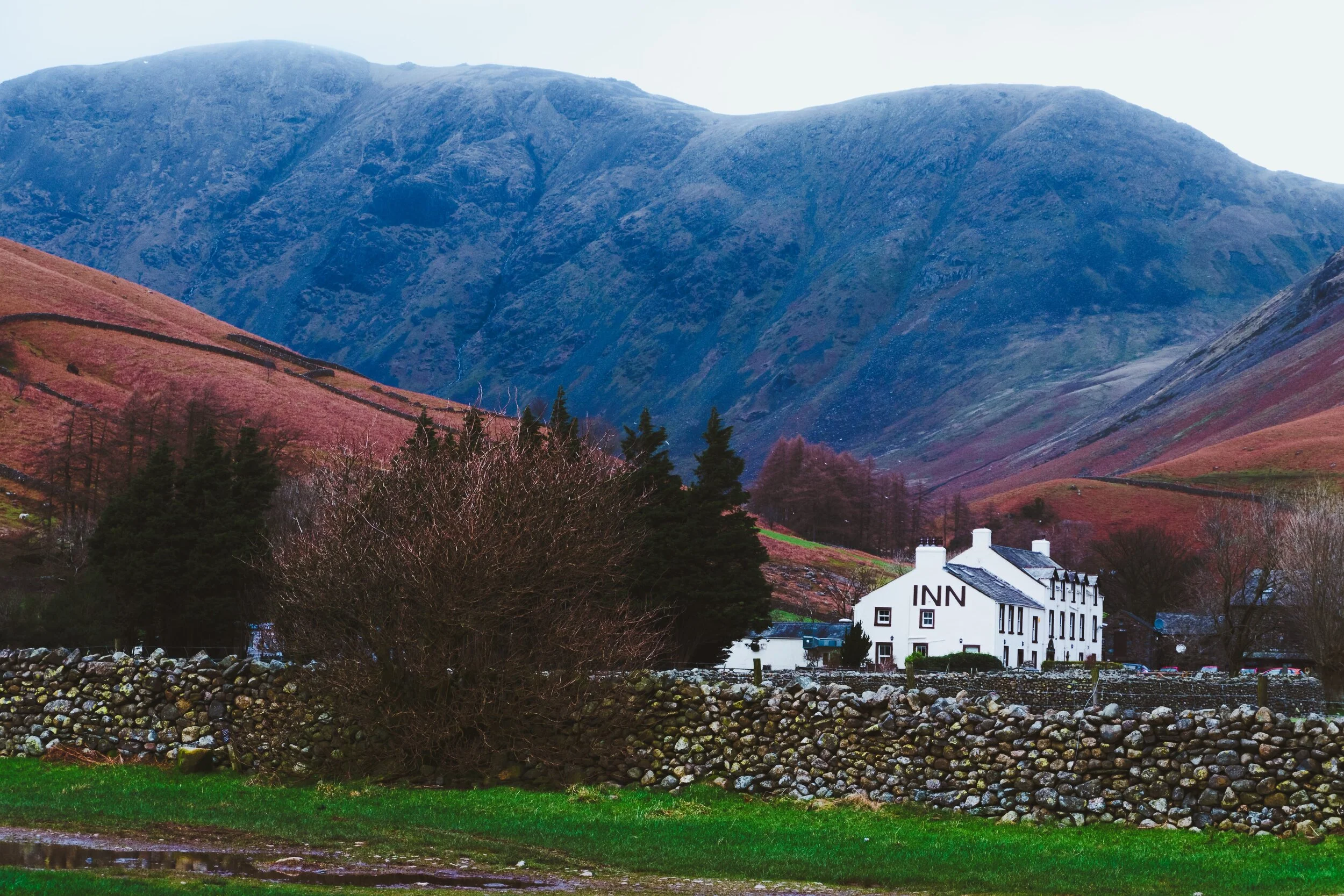 The Wasdale Head Inn, formerly the Wastwater Hotel, which has served travellers for over 200 years. The Pillar range of fells loom above.