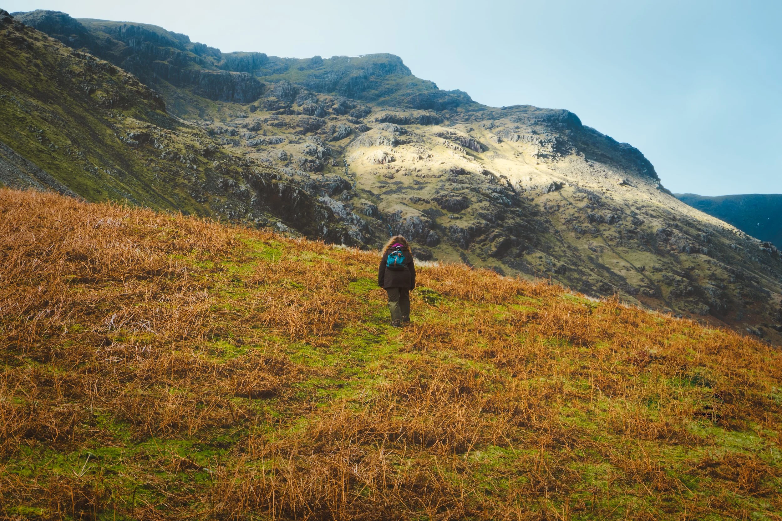Making our up the side of the Mosedale valley, with the hulking crags of Red Pike (826 m/2,710 ft) in front of us. Another beam of light from the clouds behind us scans down the crags.