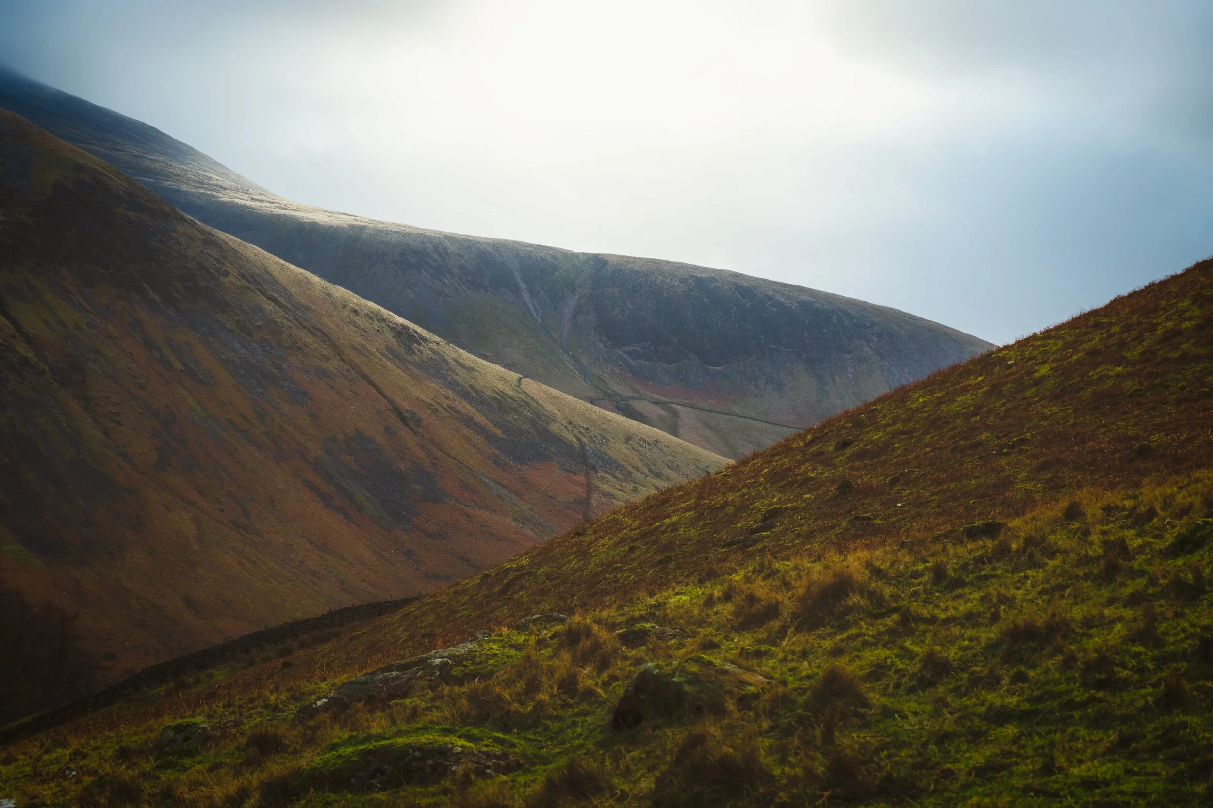 Zooming in from Mosedale to shoot some of that gorgeous light escaping the clouds and hitting the slopes of Lingmell and Scafell. I also loved framing the shot with all these diagonal lines crossing up and down.