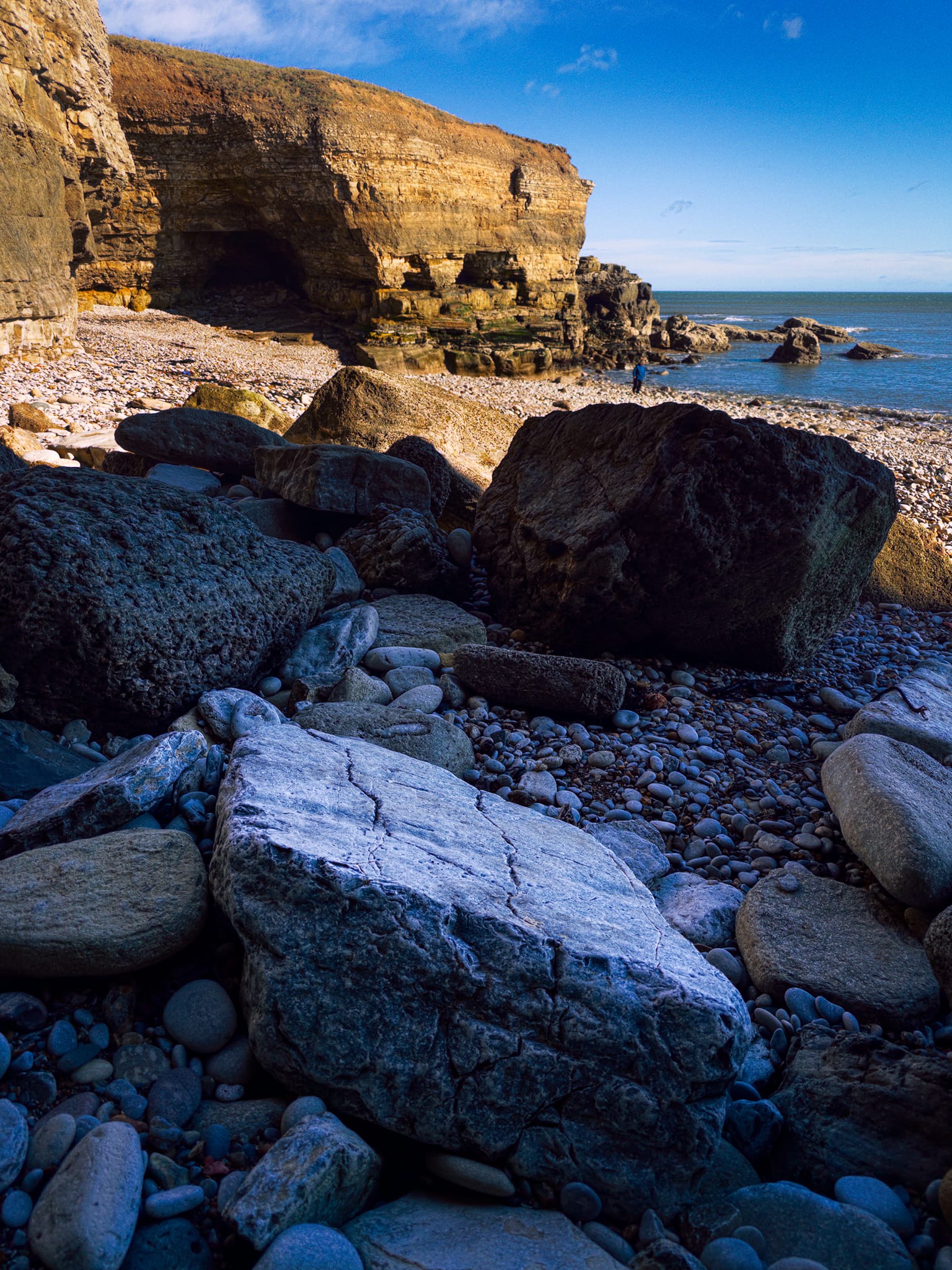 I tucked myself away into the shadow of another inlet, getting close to these fallen boulders and letting the cliffs in the distance provide both colour and luminance contrast. One of my favourite images.
