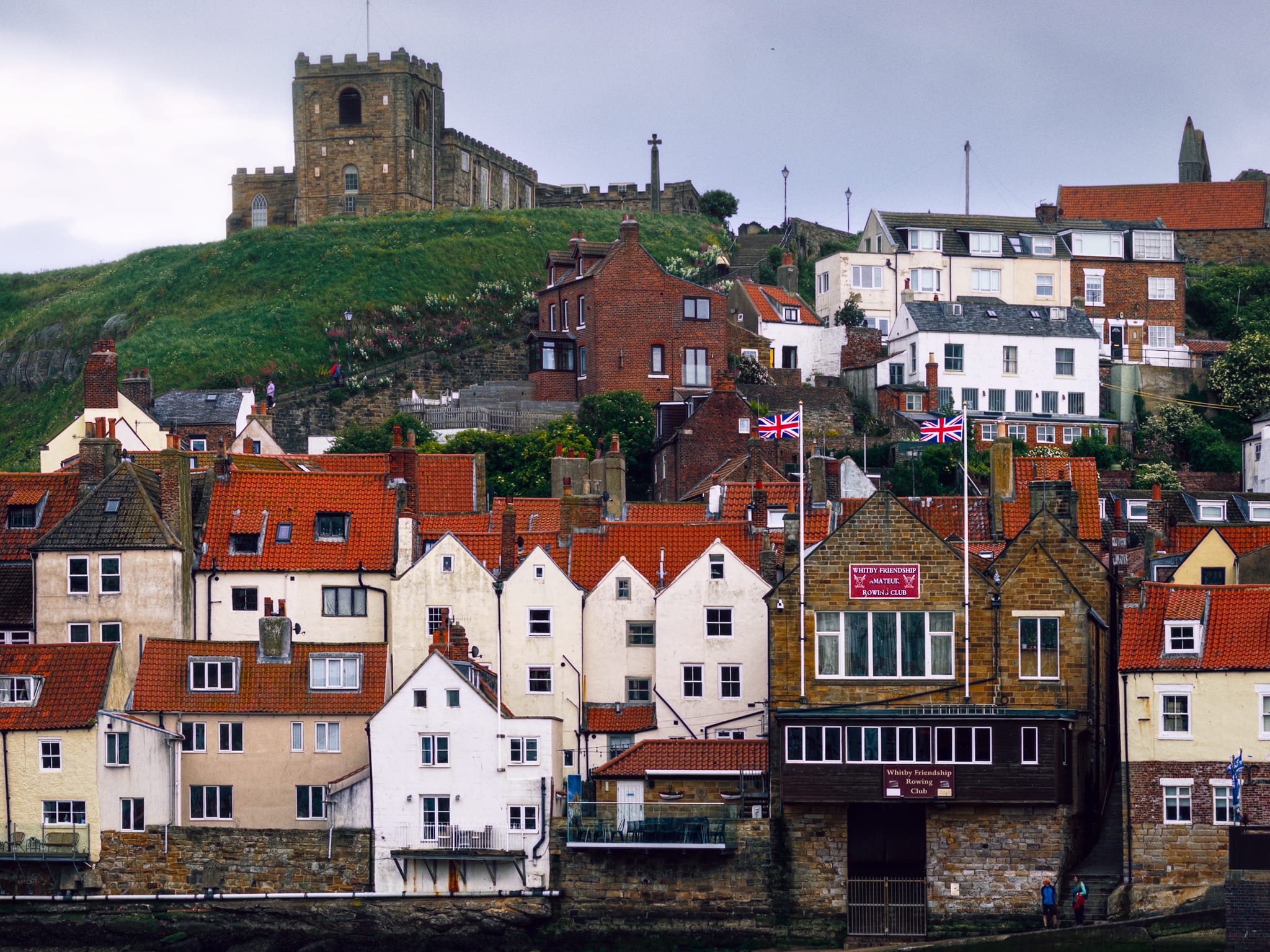A tighter shot of the seemingly chaotic arrangement of houses, pubs, restaurants, and shops that make up the lower slopes of Whitby&rsquo;s east cliffs. A bit of a mess, but beautiful nonetheless.