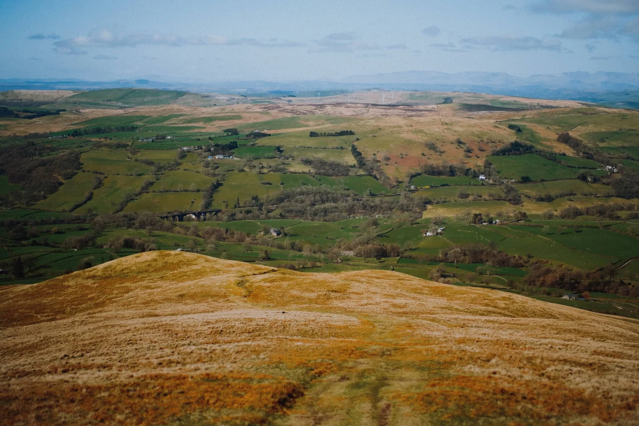 After a flapjack and some water whilst sheltered underneath the trig point from the wind, we followed the track back down the southwestern shoulder of Winder.